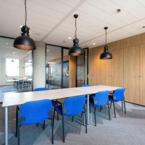 The meeting room interior of a modern office with a long wooden table and chairs around it